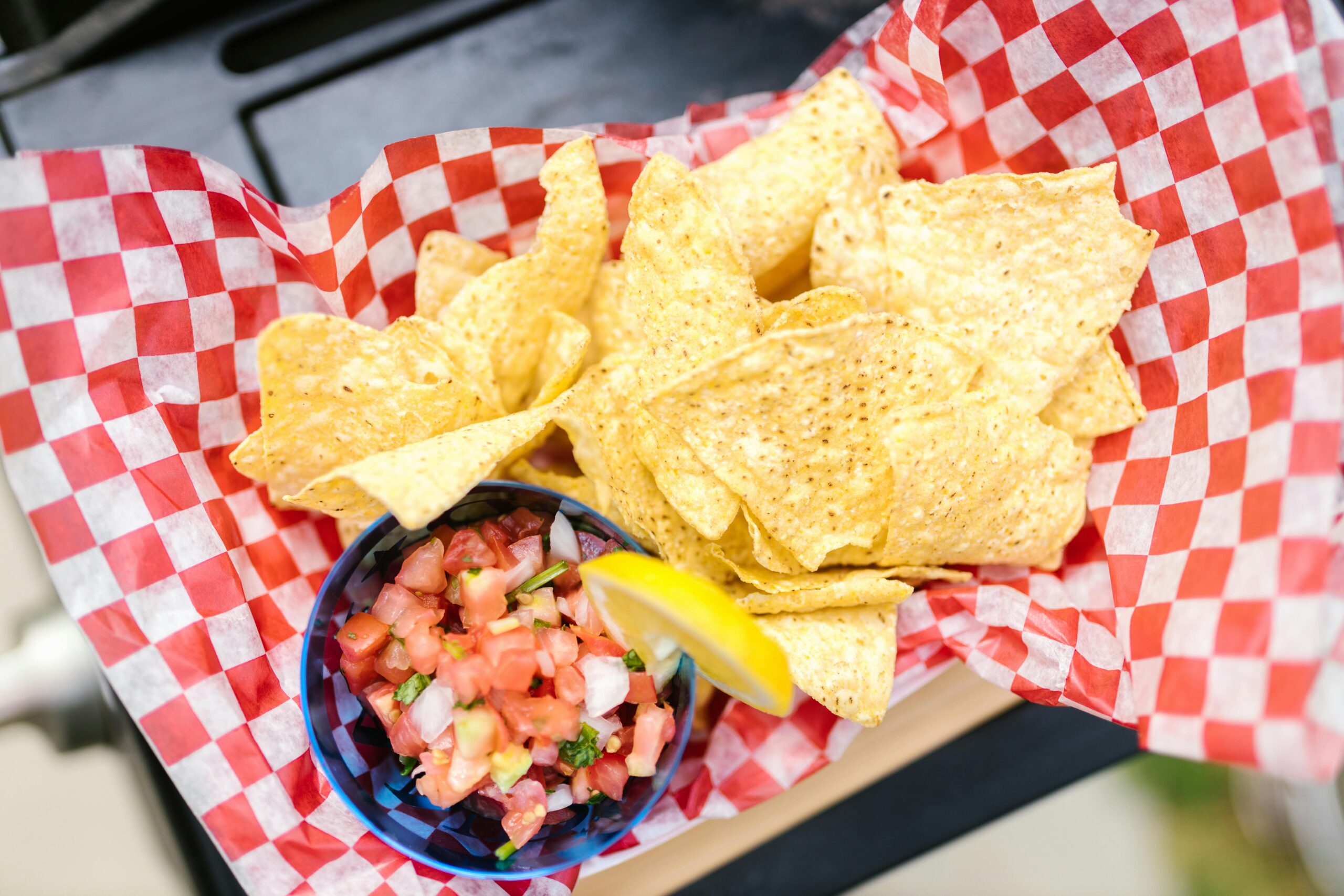 Enjoy crispy nachos served with fresh, colorful pico de gallo and a slice of lemon.